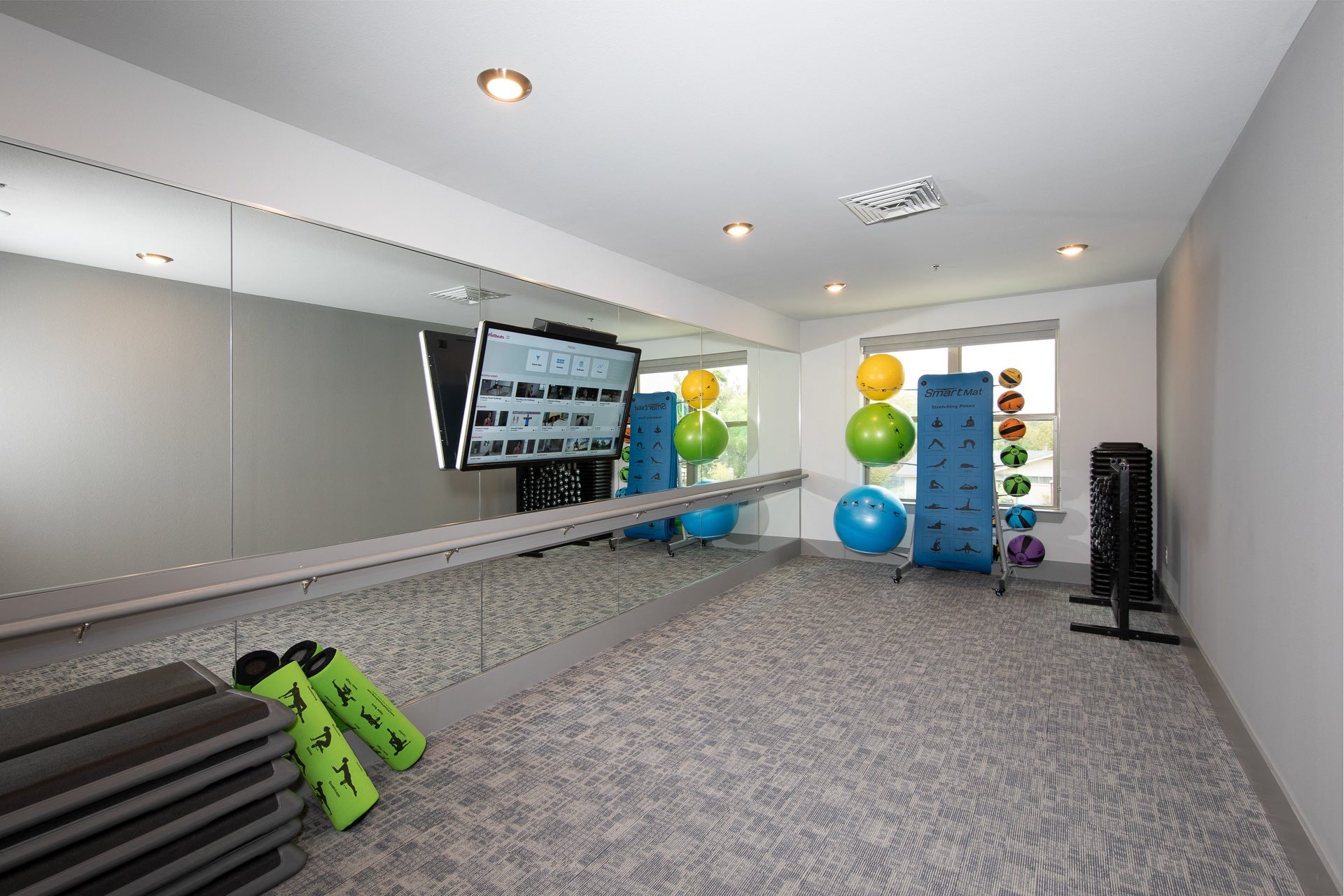 a fitness room with workout equipment at a senior apartment community